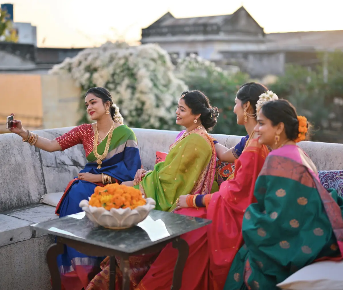 Women in traditional attire taking a selfie