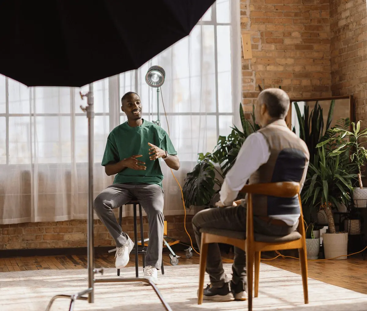 Interview in a sunlit room with plants.