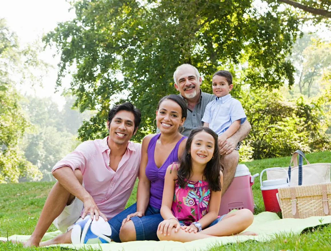 Outdoor family gathering with picnic baskets