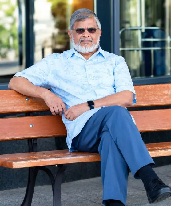 Man sitting on a bench outdoors.
