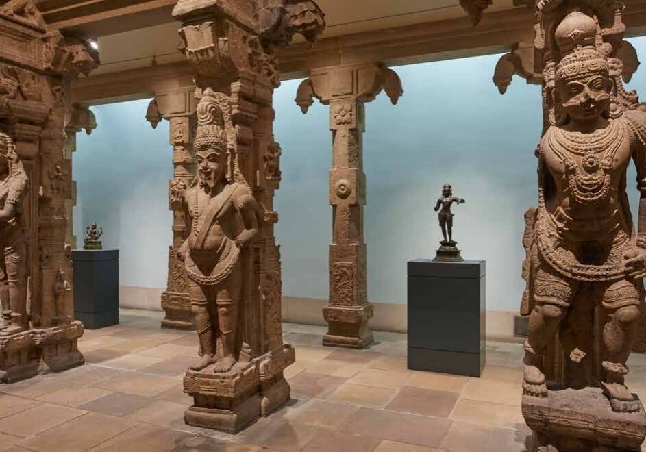 Ancient stone sculptures in museum setting.
