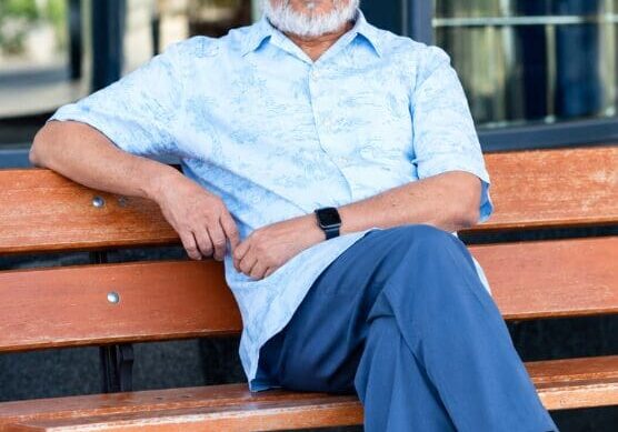 Man sitting on a bench outdoors.